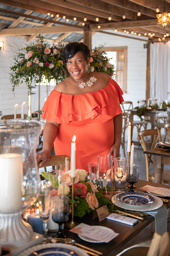 Shaun Mosley in a pretty coral dress, wedding table setting in a white barn in chattanooga tennessee